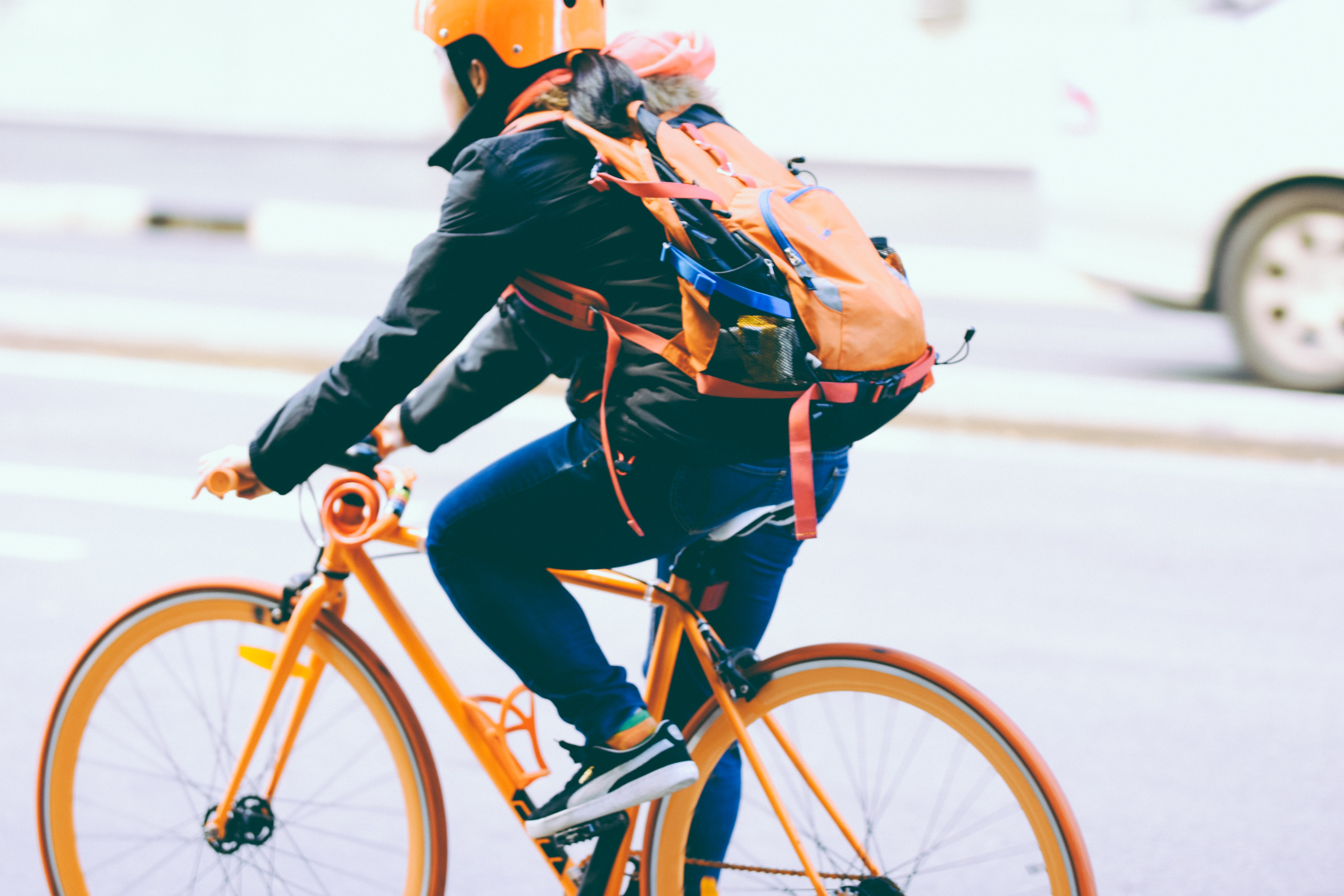 Woman wearing helmet bikes to work.