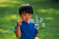 Kid blowing bubbles