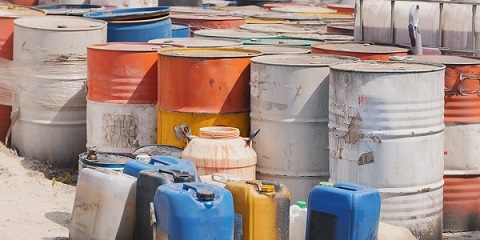 Barrels stand with spent oil products