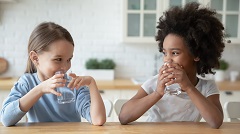 Two girls drink water