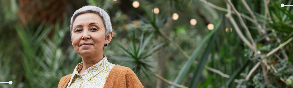 Elderly woman smiling towrads the camera.