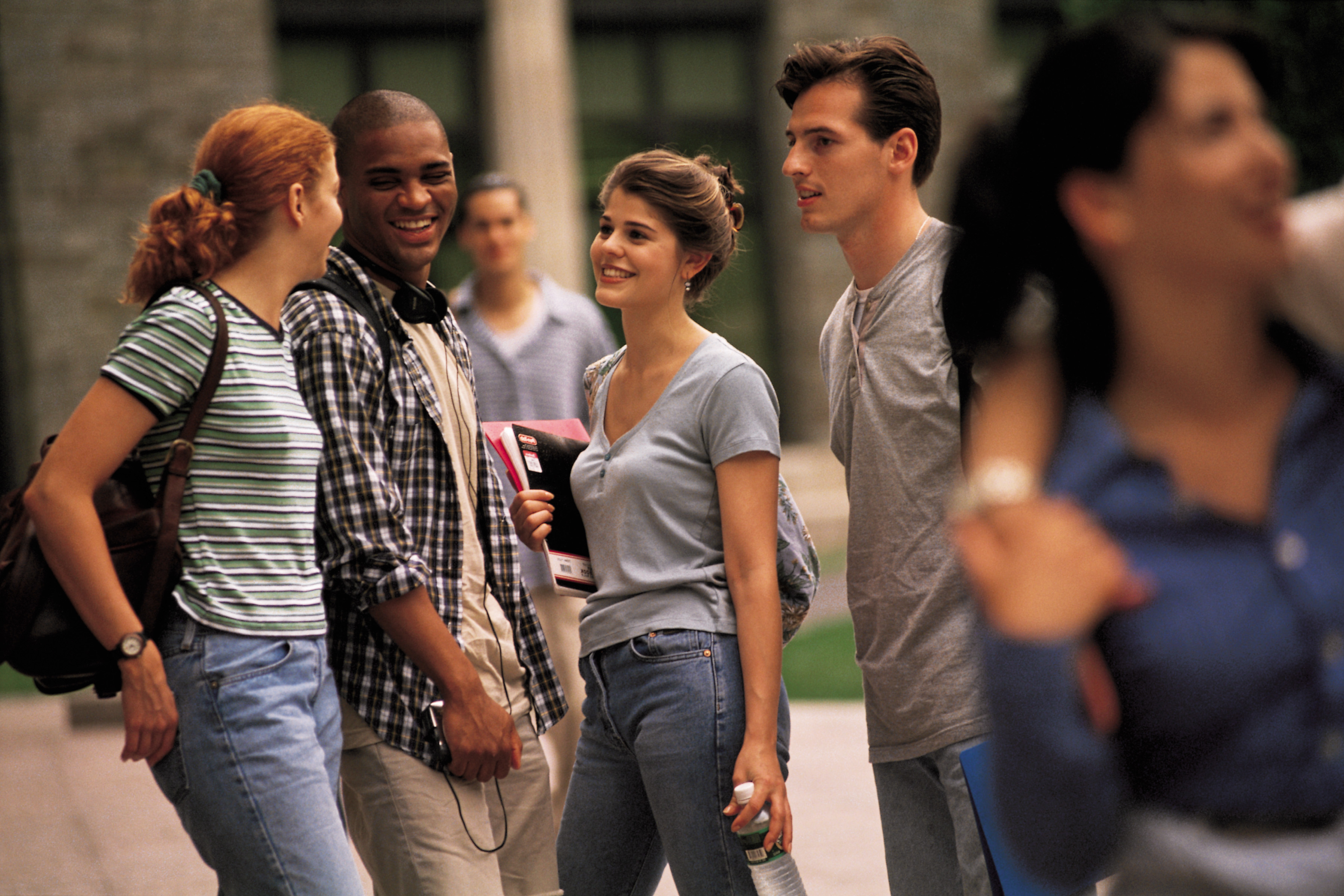 multi-ethnic teenagers talking at school