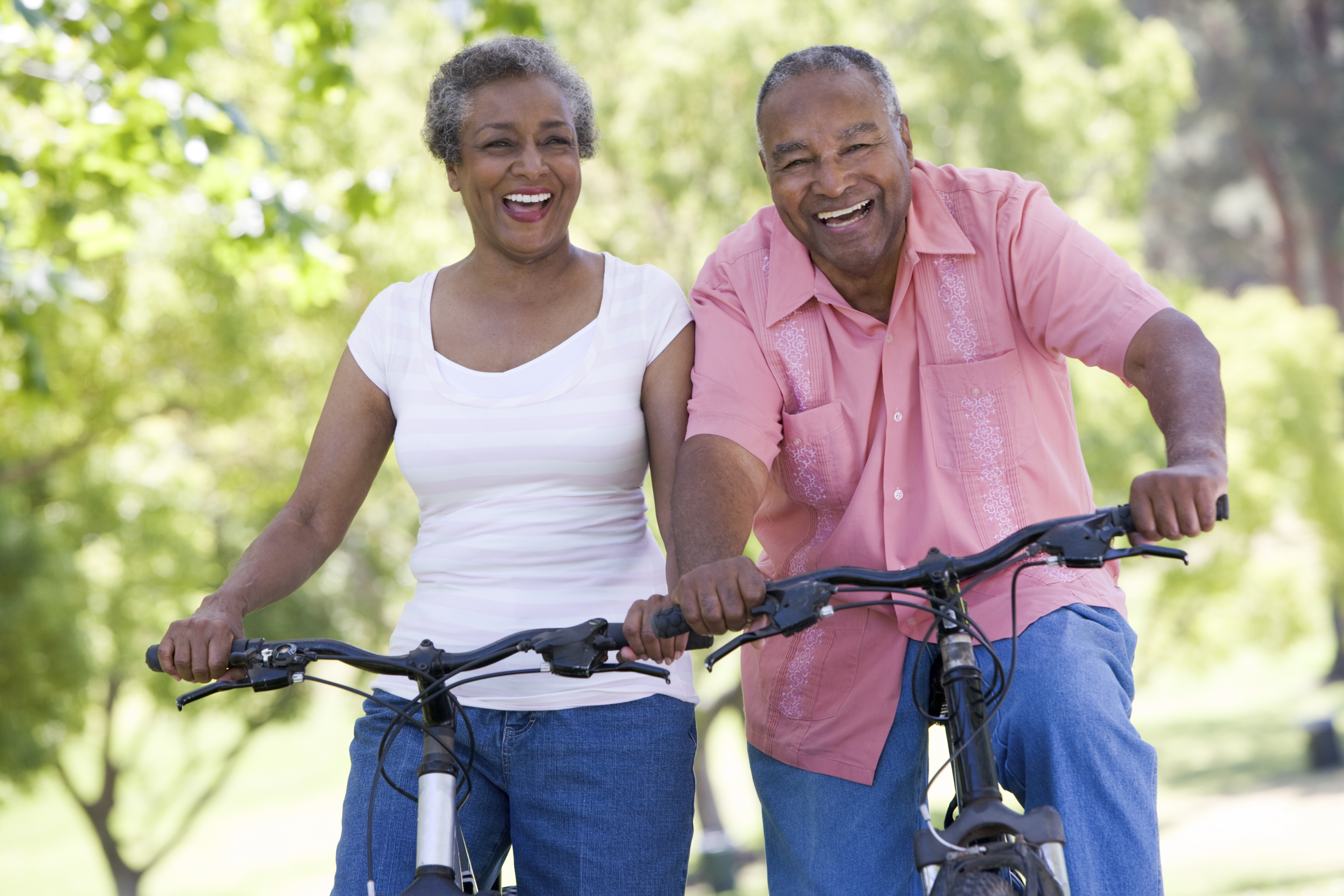 Senior African American couple riding bicycles