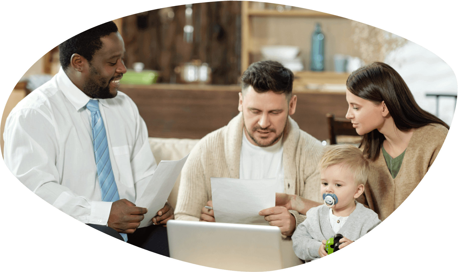 Smiling African American professional in white shirt and blue tie discussing document with parents of toddler