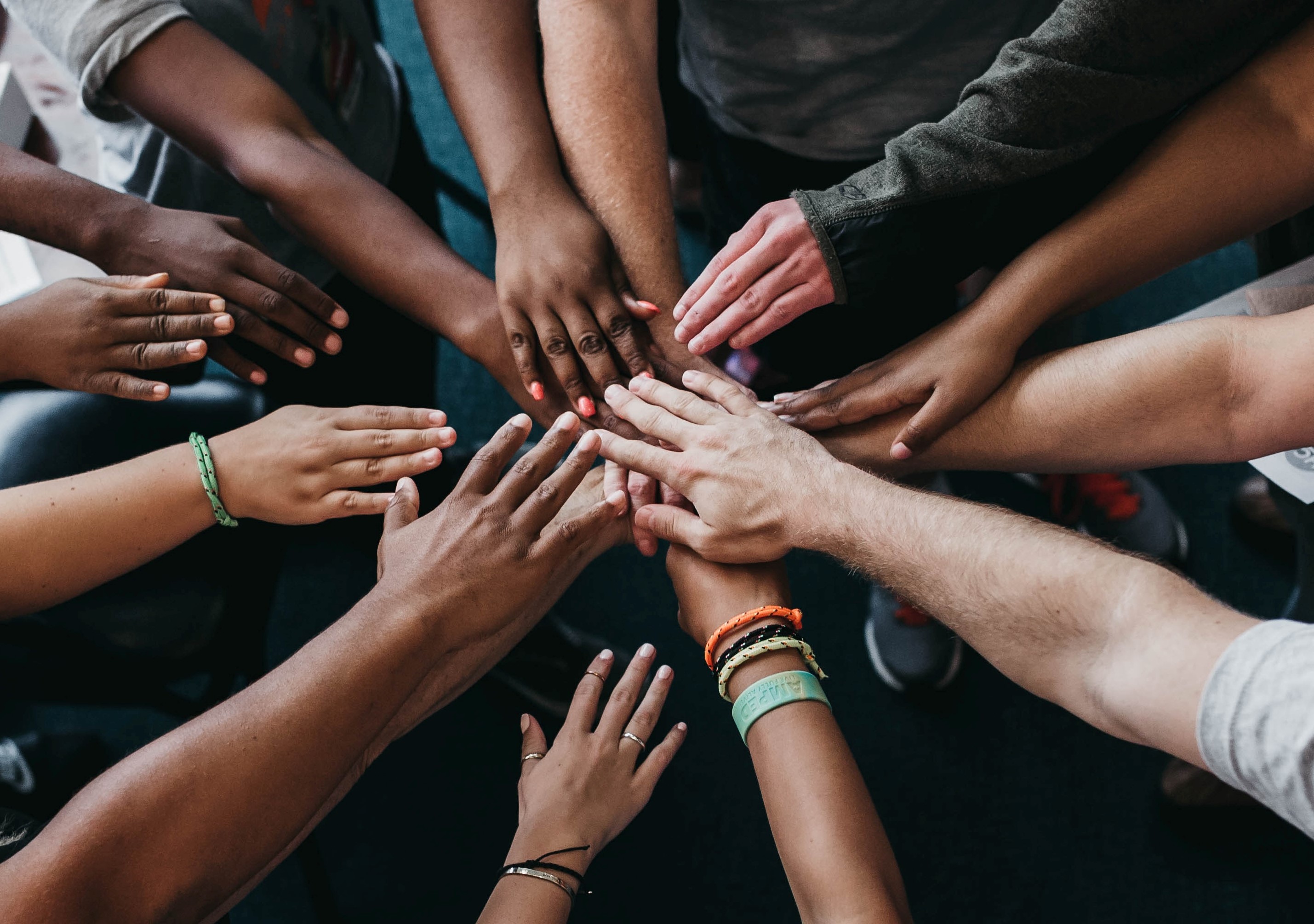 Group of hands forming a huddle